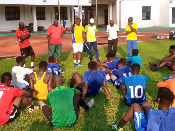Real Tamale United coach Shaibu Ibrahim Tanko (standing 3rd from left) issuing out instructions to players during one of their training sessions at the Aliu Mahama Sports Stadium