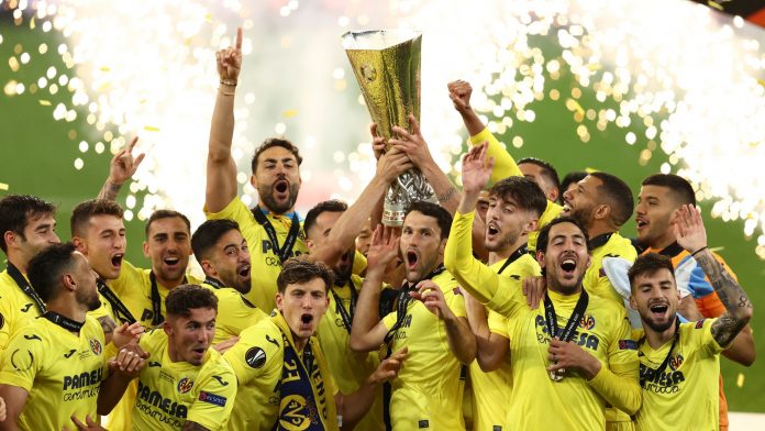 Villarreal players celebrate with the trophy after winning the Europa League