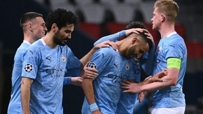 Man City players celebrate with Riyad Mahrez