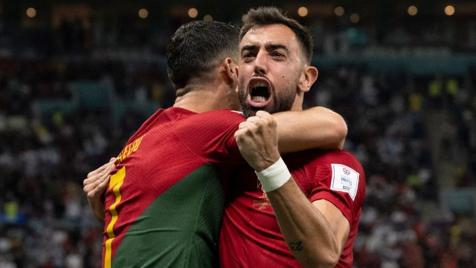 Bruno Fernandes celebrates with Cristiano Ronaldo after giving Portugal the lead
