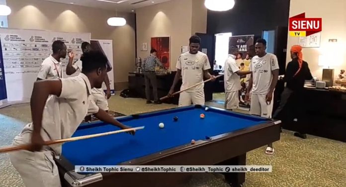 Afriyie Barnieh and Thomas in a game of snooker in camp