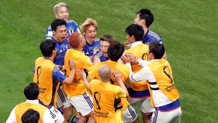 Japan's Ritsu Doan celebrates scoring his side's first goal of the game with team-mates