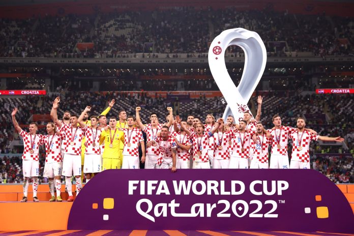 DOHA, QATAR - DECEMBER 17: Croatia players and team officials celebrate with their FIFA World Cup Qatar 2022 third placed medals after the team's victory during the FIFA World Cup Qatar 2022 3rd Place match between Croatia and Morocco at Khalifa International Stadium on December 17, 2022 in Doha, Qatar. (Photo by Maddie Meyer - FIFA/FIFA via Getty Images)