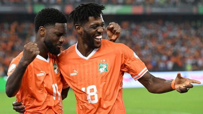 Jean-Philippe Krasso celebrates with Ibrahim Sangare after scoring Ivory Coast's second goal in the 58th minute